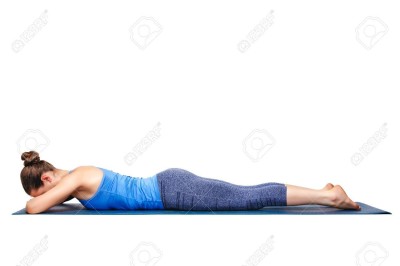 Woman relaxes in yoga asana Makarasana